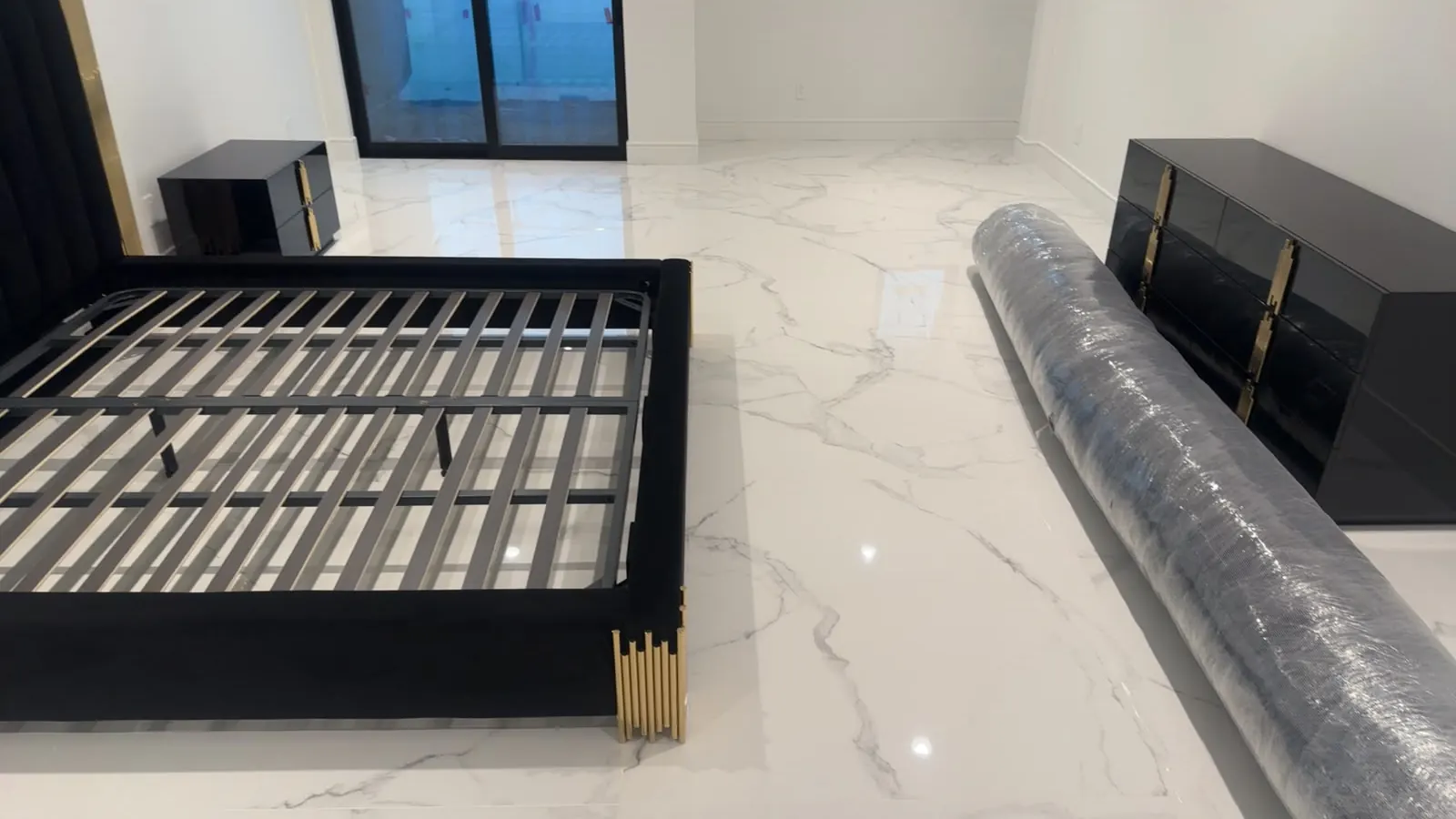 Bedroom floor of large white marble-look tiles with grey veins